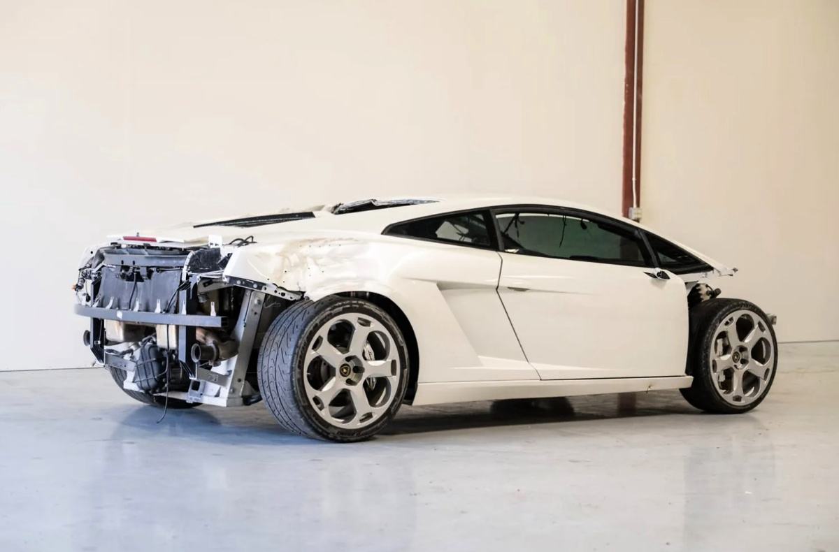 Lamborghini Gallardo branco visto de lado, sem a traseira e com a estrutura interna exposta.